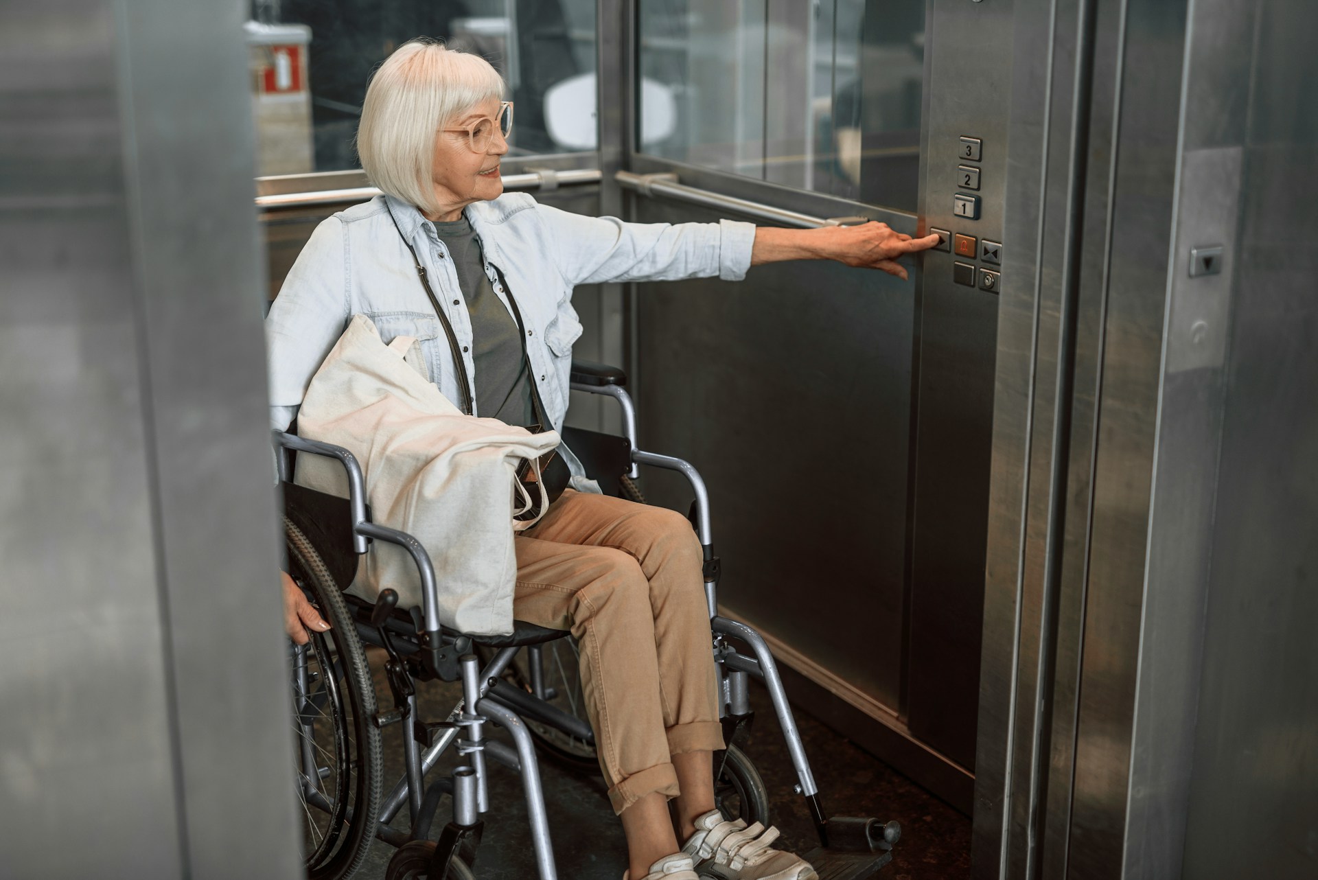 woman in wheelchair riding the elevator