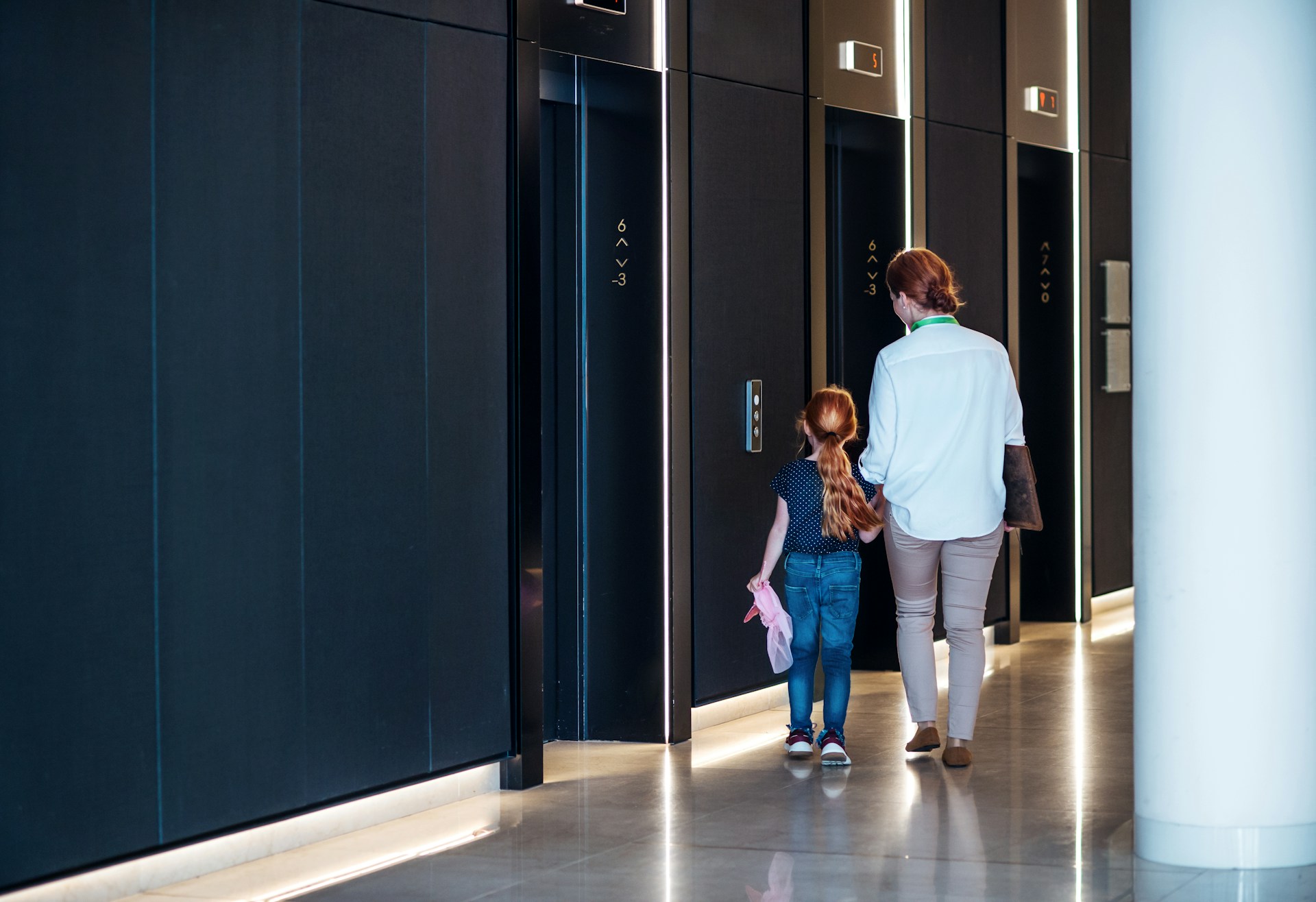 mother and daughter walking to elevator