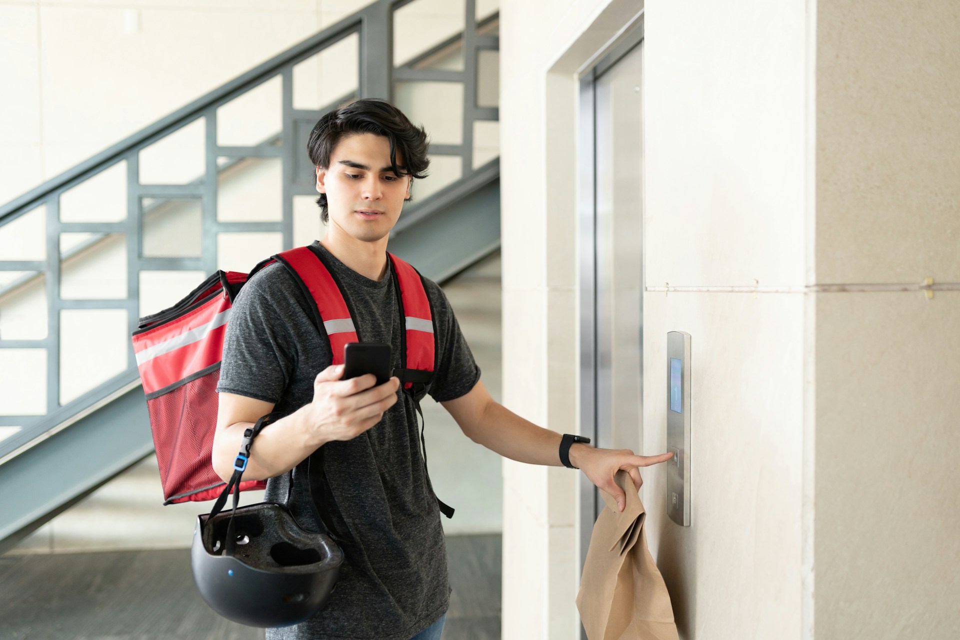 delivery man about to ride an elevator